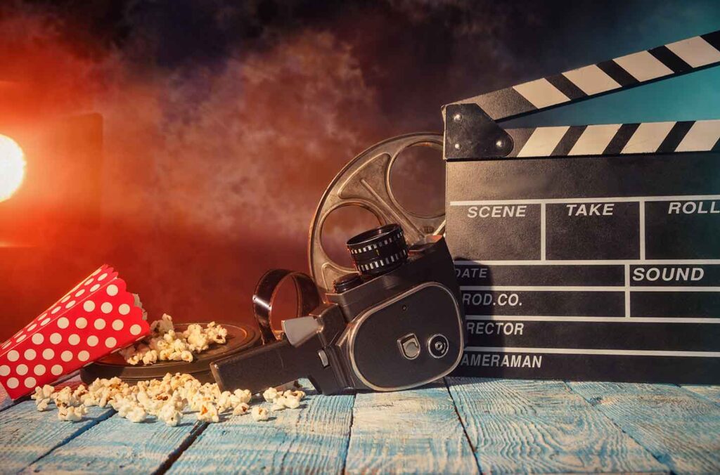 Image of popcorn, movie camera and chalkboard