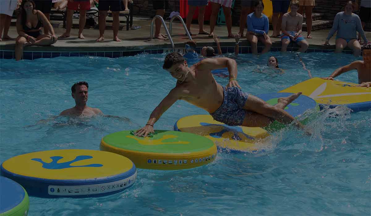 Image of man falling into pool during our competition at Woodloch Resort