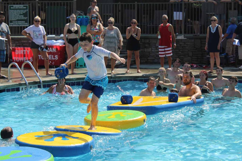 Image of young man participating in Woodloch Pool Games